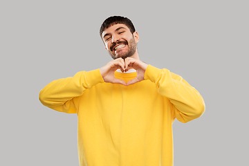 Image showing smiling young man in yellow sweatshirt