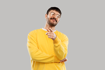 Image showing man in yellow sweatshirt pointing finger to camera