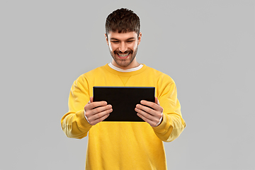 Image showing smiling young man with tablet pc computer