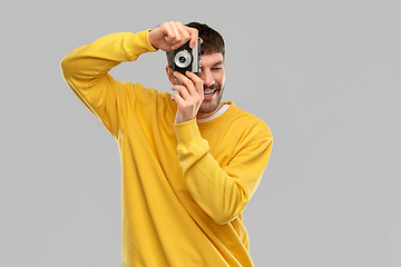 Image showing happy smiling young man with vintage film camera