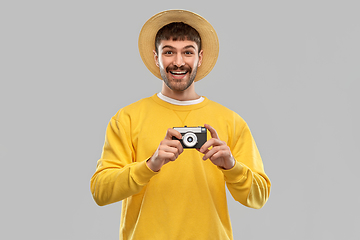 Image showing happy man in straw hat with vintage film camera