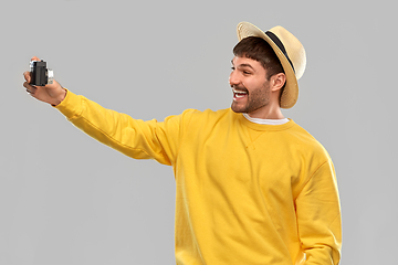 Image showing happy man in straw hat with vintage film camera