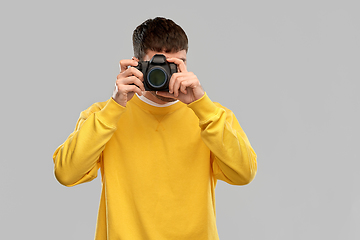 Image showing young man with digital camera