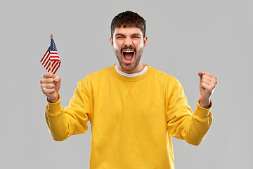 Image showing man in yellow sweatshirt with flag of america