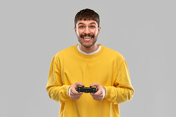 Image showing man or gamer with gamepad playing video game