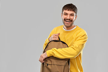 Image showing happy smiling young man with backpack