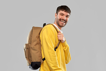 Image showing happy smiling young man with backpack