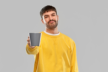 Image showing displeased young man with coffee cup