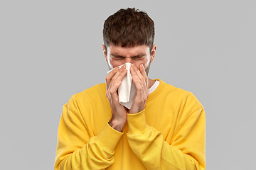 Image showing man with paper napkin blowing nose