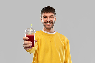 Image showing happy man with tomato juice in takeaway cup