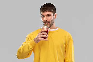 Image showing happy man with tomato juice in takeaway cup