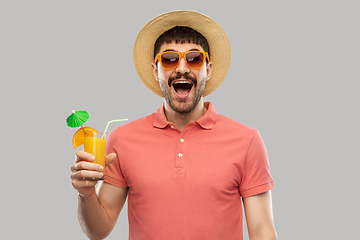 Image showing happy man in straw hat with orange juice cocktail