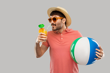 Image showing happy man with orange juice and beach ball