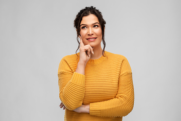 Image showing thinking smiling young woman with pierced nose