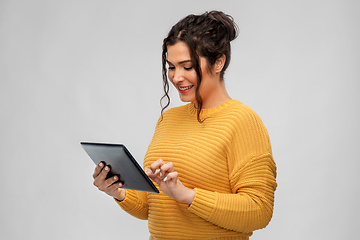 Image showing happy young woman using tablet pc computer