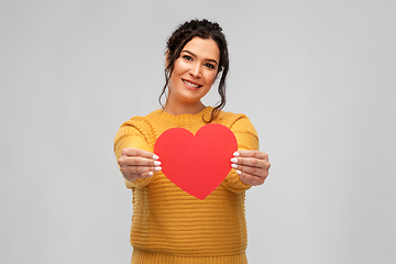 Image showing happy smiling young woman with red heart