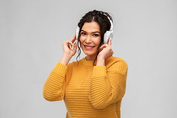 Image showing happy woman in headphones listening to music