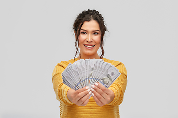 Image showing happy smiling young woman with dollar money