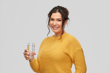 Image showing smiling young woman with water in glass