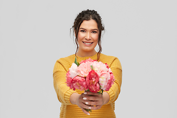 Image showing happy smiling young woman with bunch of flowers