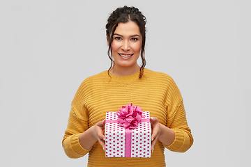 Image showing smiling young woman holding gift box