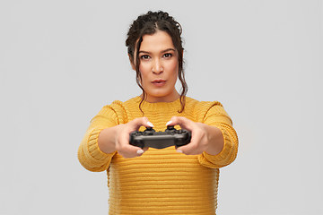 Image showing happy young woman with gamepad playing video game