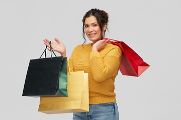 Image showing happy smiling young woman with shopping bags