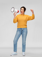 Image showing angry young woman speaking to megaphone