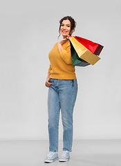 Image showing happy smiling young woman with shopping bags