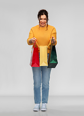 Image showing happy smiling young woman with shopping bags