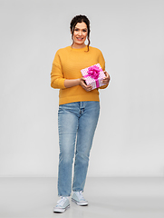 Image showing smiling young woman with gift box