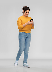 Image showing happy woman using smartphone