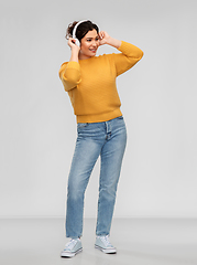 Image showing happy woman in headphones listening to music