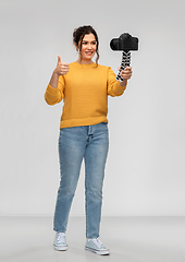 Image showing smiling woman blogger with camera recording video