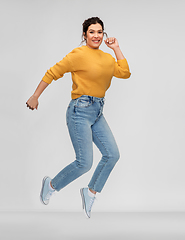 Image showing happy young woman with pierced nose jumping