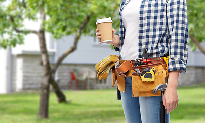 Image showing woman with takeaway coffee cup and working tools