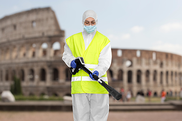 Image showing sanitation worker in hazmat with pressure washer