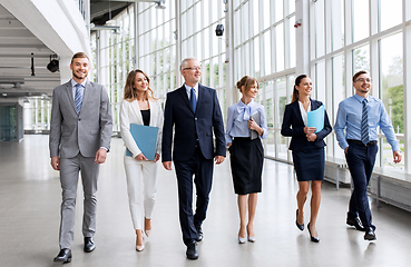 Image showing business people walking along office building