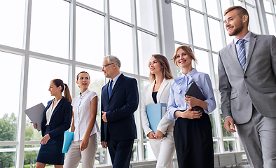 Image showing business people walking along office building