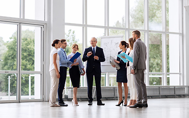 Image showing business team with scheme on flip chart at office