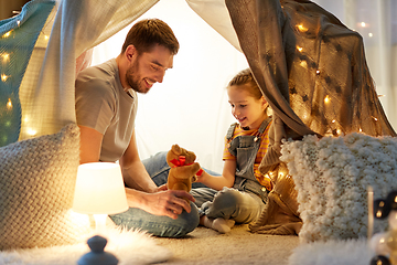 Image showing happy family playing with toy in kids tent at home