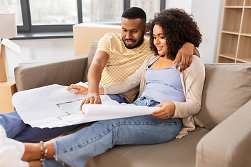 Image showing couple with boxes and blueprint moving to new home