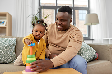 Image showing african family playing with baby daughter at home