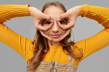 Image showing teenage girl looking through finger glasses