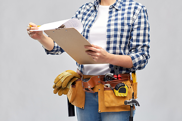 Image showing woman with clipboard, pencil and working tools