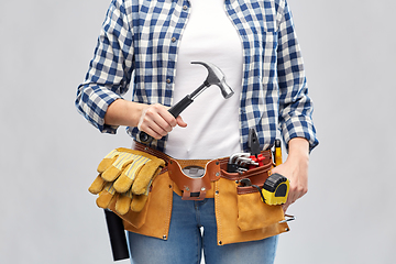 Image showing woman with hammer and working tools on belt