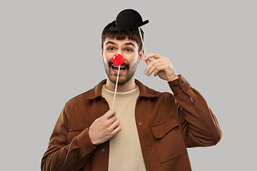 Image showing smiling man with bowler hat and red clown nose