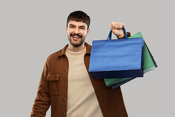 Image showing happy smiling young man with shopping bags