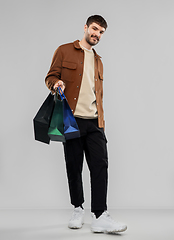 Image showing smiling young man with shopping bags