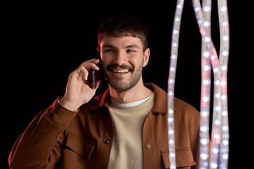 Image showing smiling young man in yellow sweatshirt